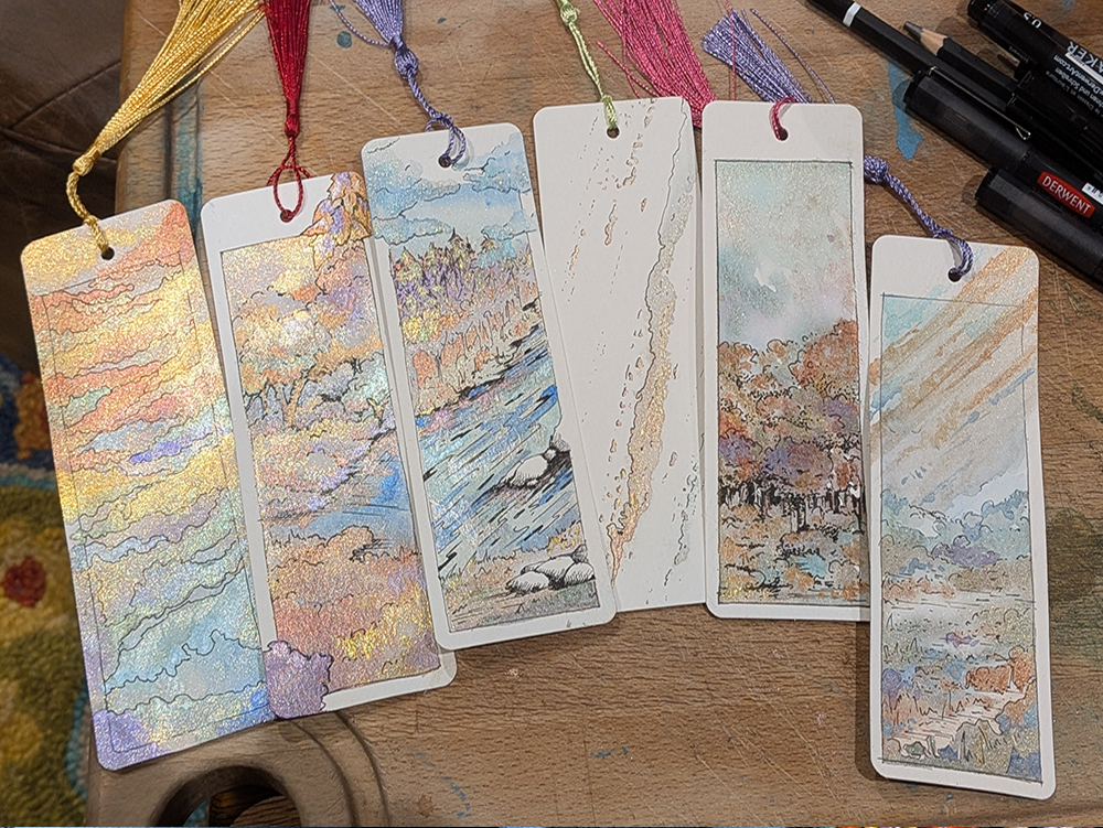 A selection of bookmarks painted with metallic watercolour