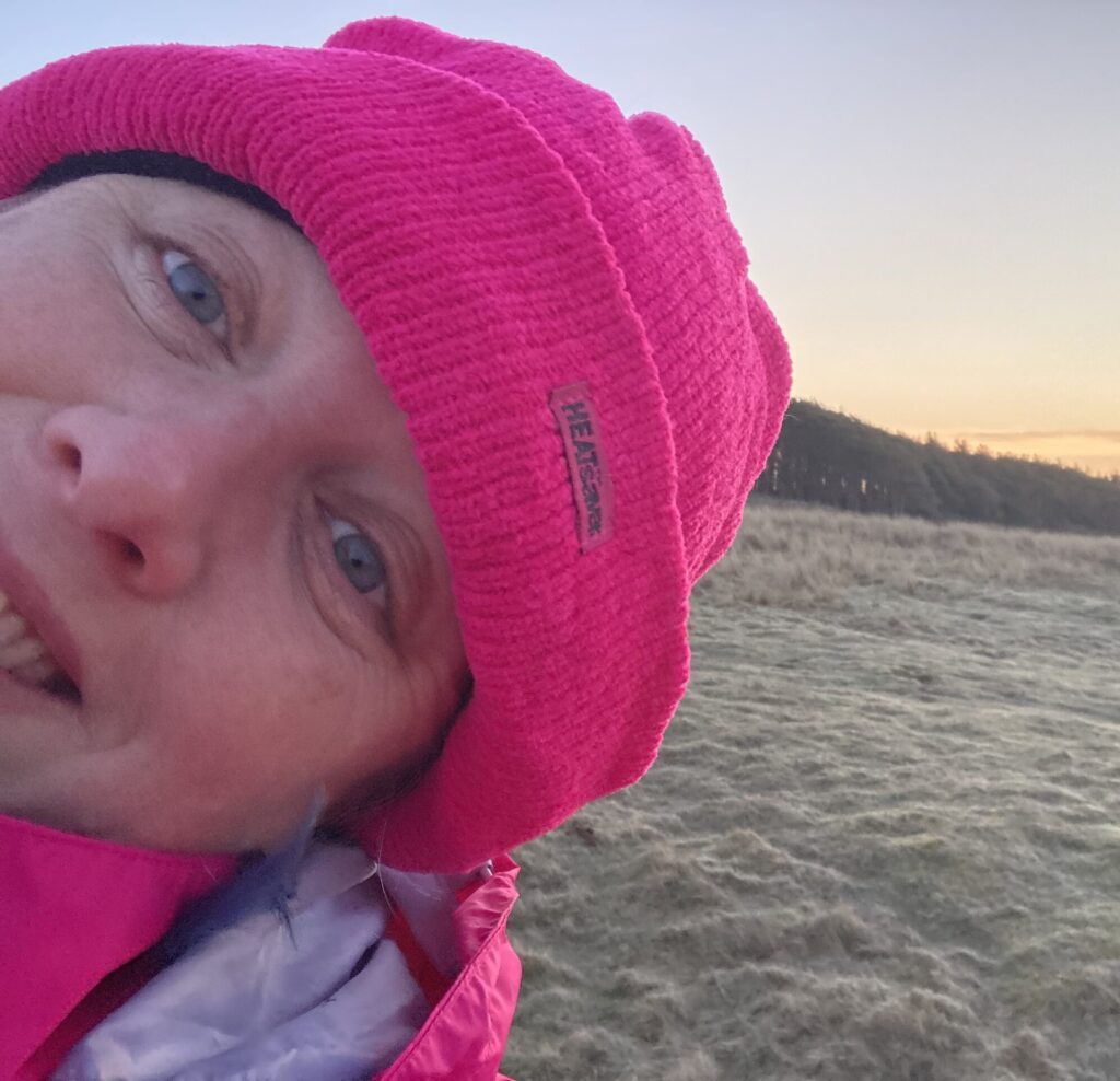 Photograph of Carleen Houbart in a pink hat